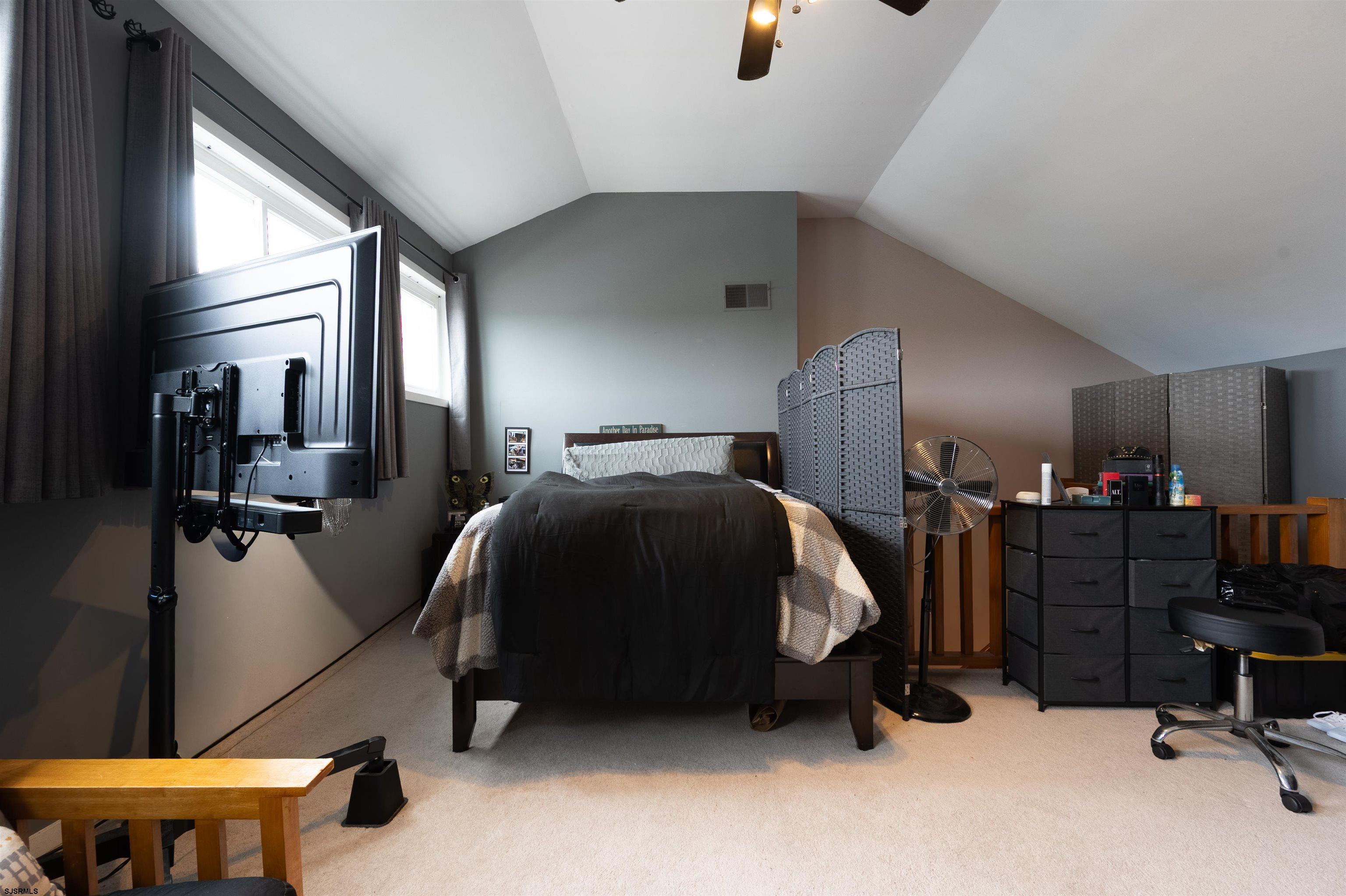 6 Marc Lane Brigantine, NJ 08203 - Photo 23 of 28 a bedroom with a bed and a chandelier