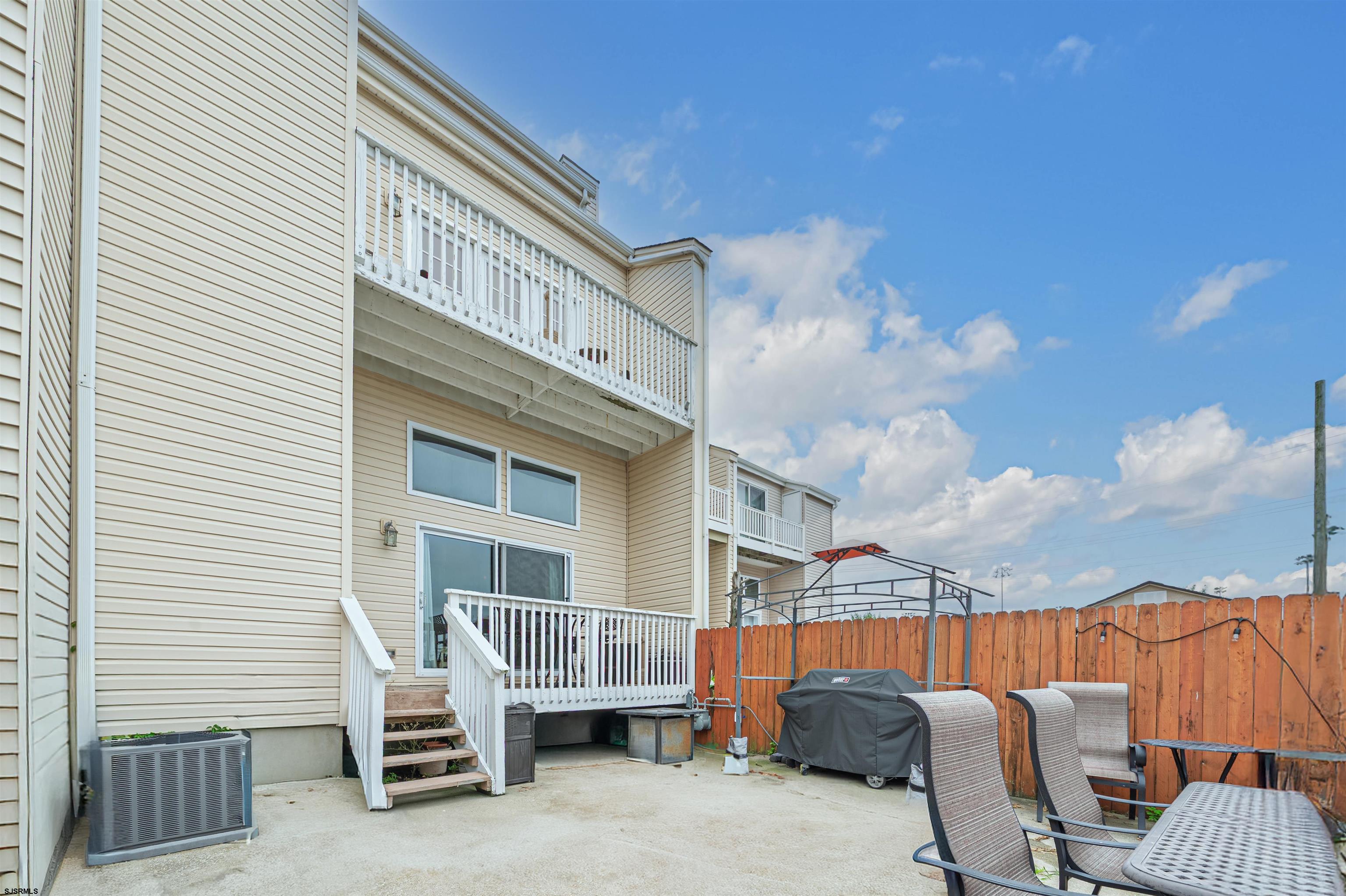 6 Marc Lane Brigantine, NJ 08203 - Photo 26 of 28 a view of balcony with two chairs and a barbeque