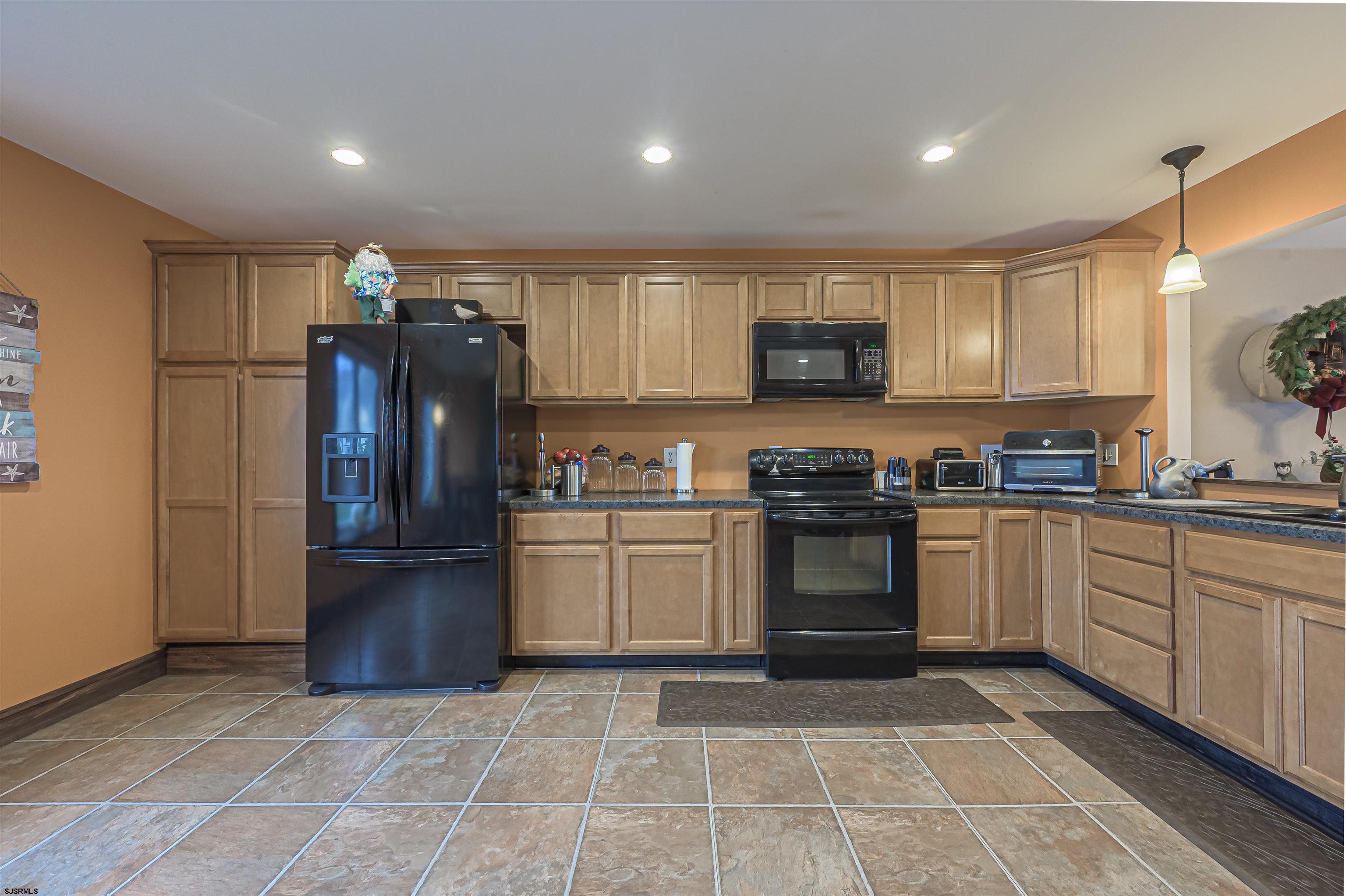 6 Marc Lane Brigantine, NJ 08203 - Photo 3 of 28 a kitchen with a refrigerator and a stove top oven
