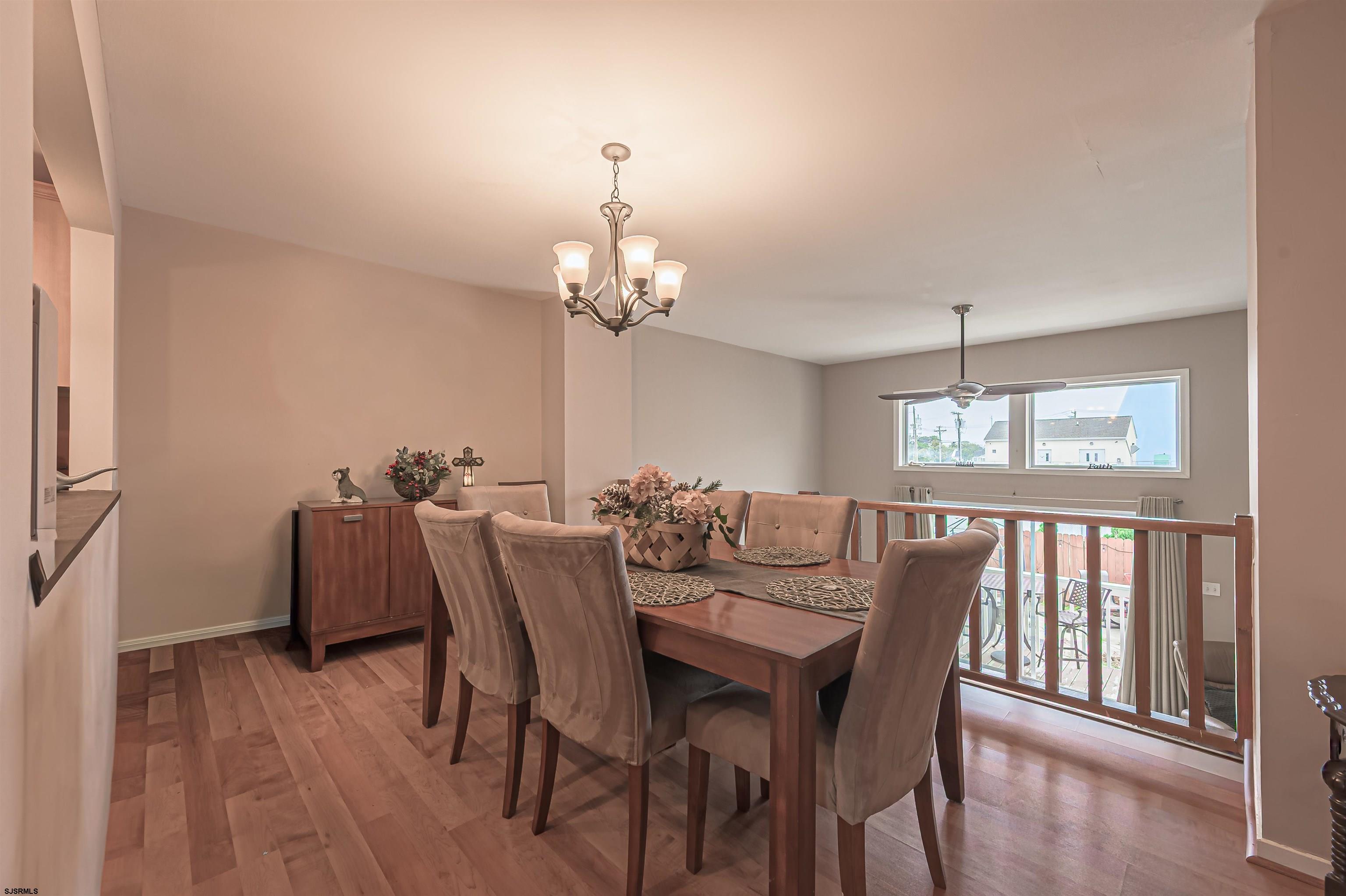 6 Marc Lane Brigantine, NJ 08203 - Photo 7 of 28 a view of a dining room with furniture window and wooden floor