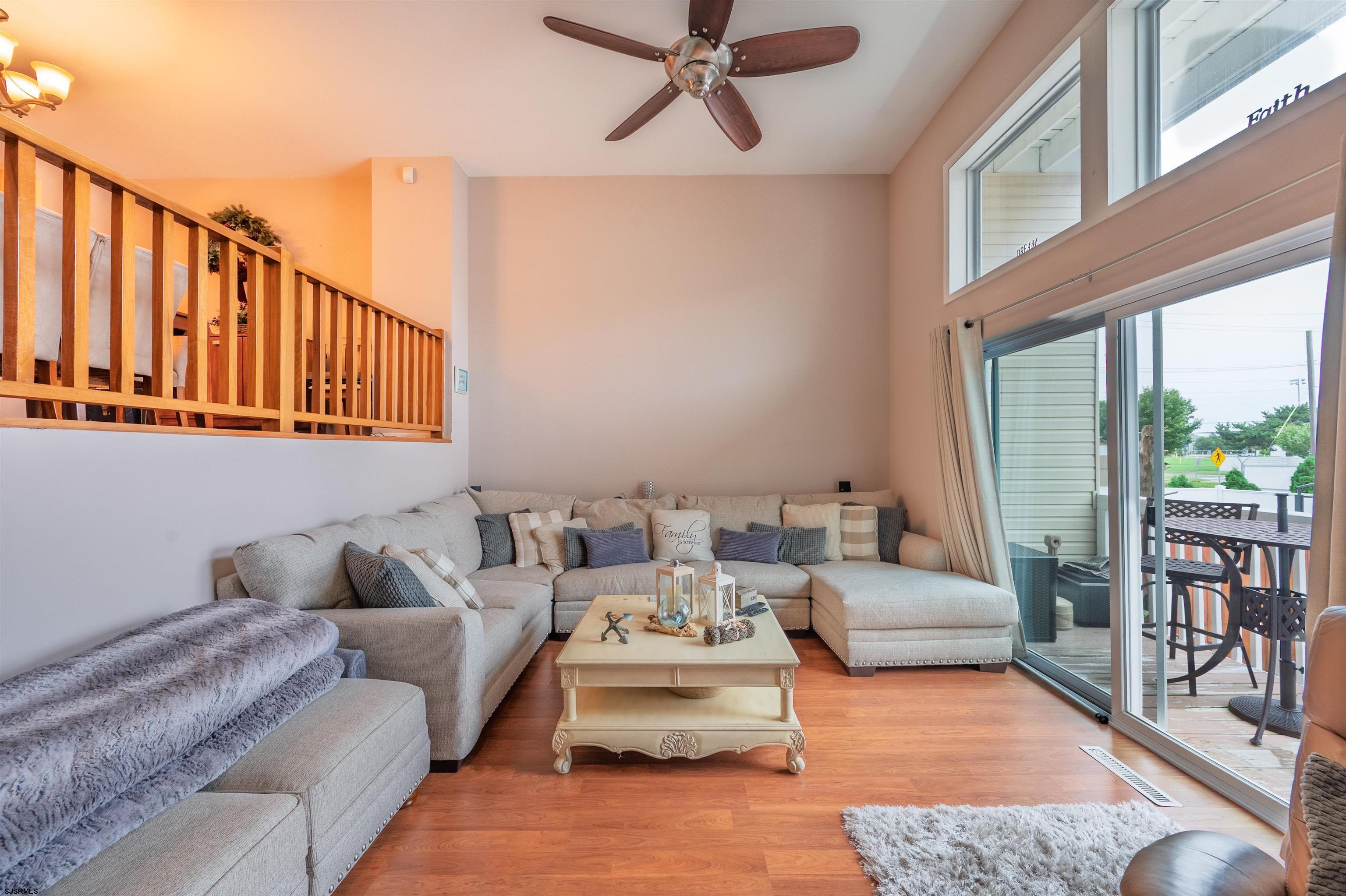 6 Marc Lane Brigantine, NJ 08203 - Photo 9 of 28 a living room with furniture floor to ceiling window and a table