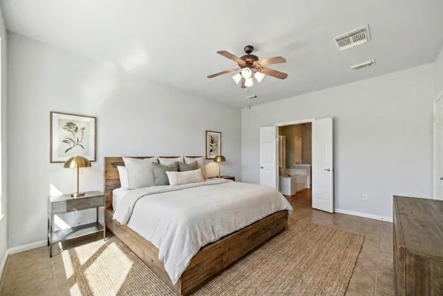 a spacious bathroom with a bathtub sink and mirror