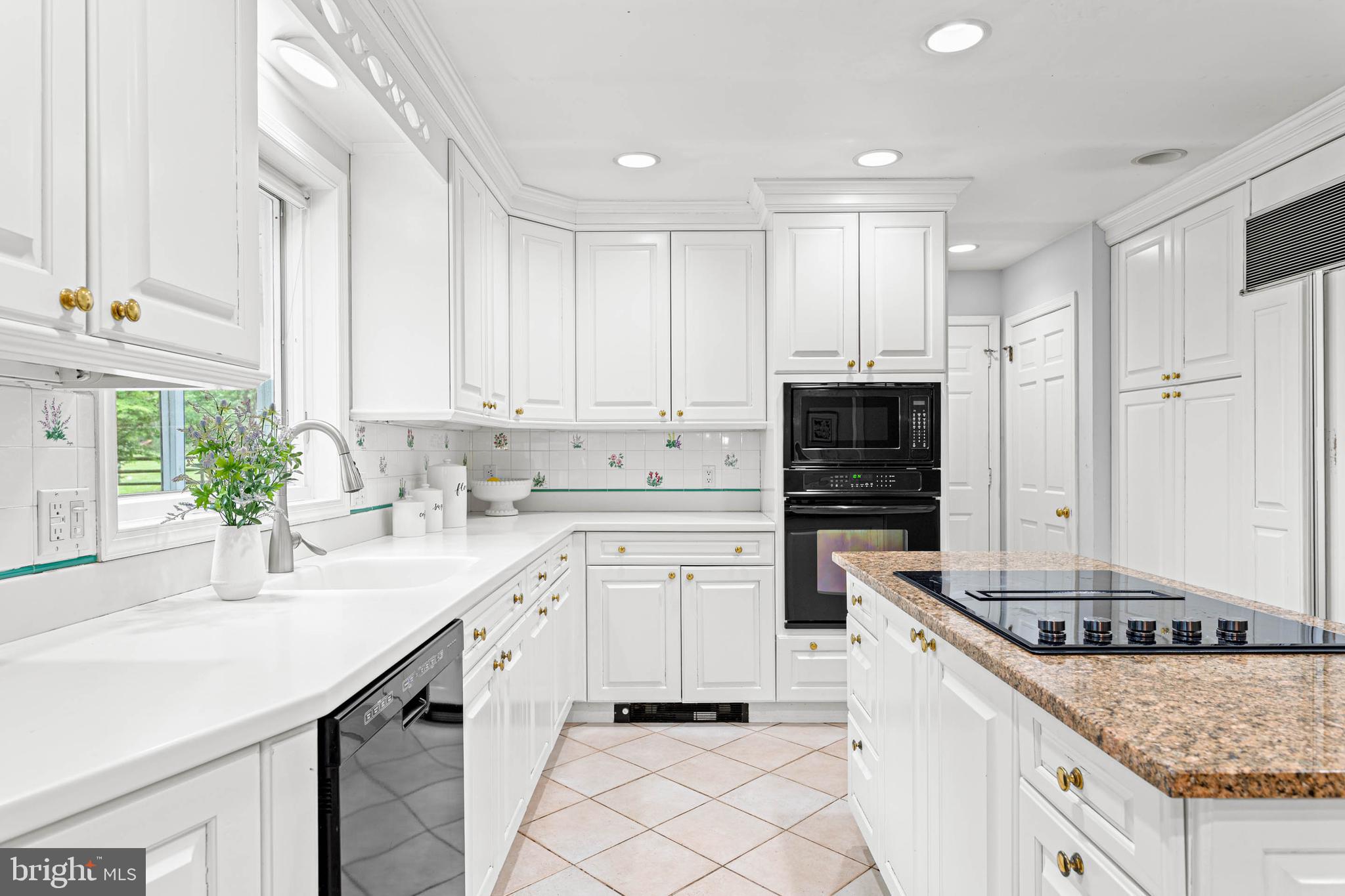 533 Gulph Road Wayne, PA 19087 - Photo 9 of 43 a kitchen with white cabinets and appliances