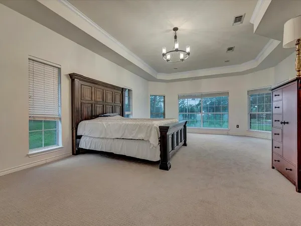 a bedroom with a bed couch and window