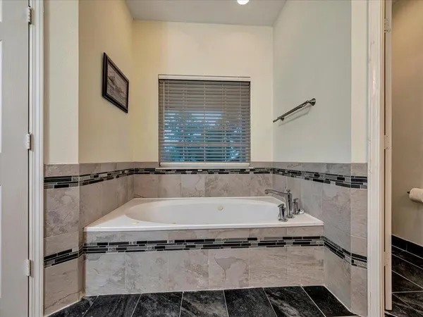 a bath tub sitting next to a shower