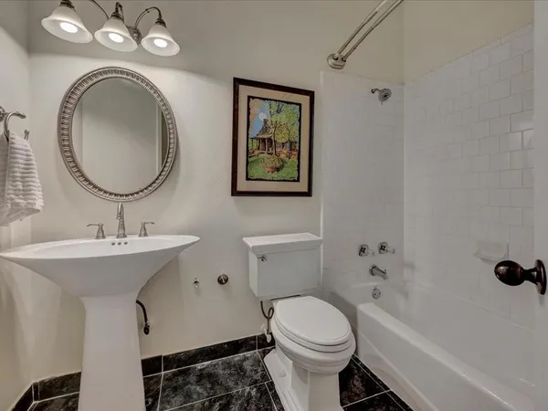 a bathroom with a toilet a sink and a mirror