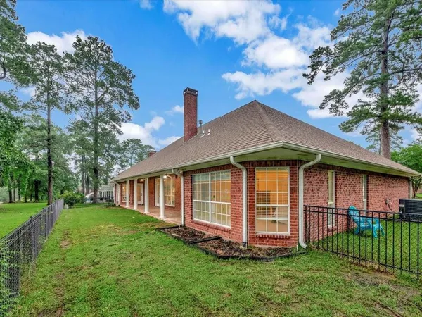a front view of a house with a garden and yard