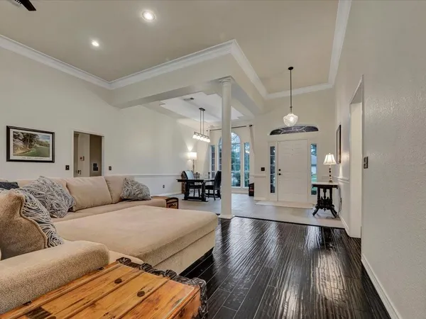 a living room with furniture and wooden floor