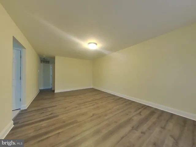 a view of an empty room and wooden floor