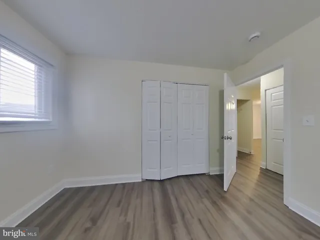 an empty room with wooden floor
