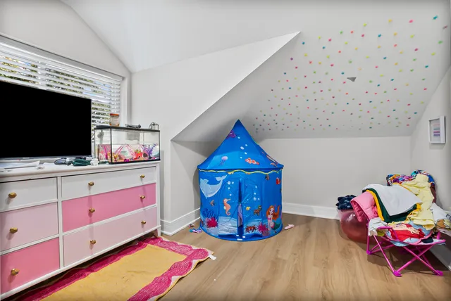 a bedroom with a bed and flat screen tv