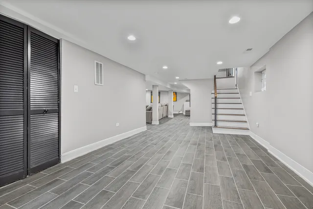 a view of a room with stairs and a wooden floor