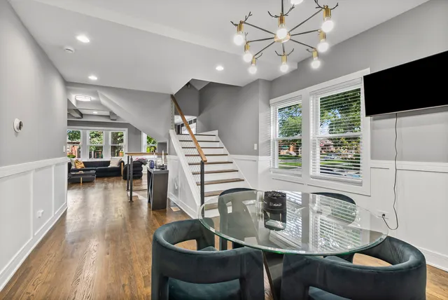 a dining room with furniture and a flat screen tv