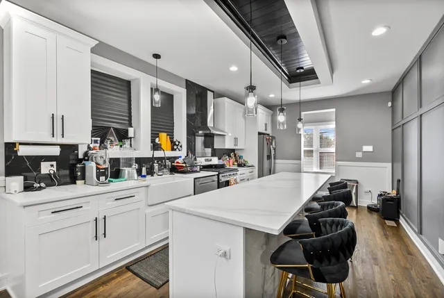 a kitchen with a sink appliances and cabinets