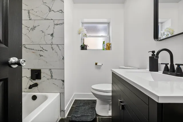 a bathroom with a sink toilet and shower