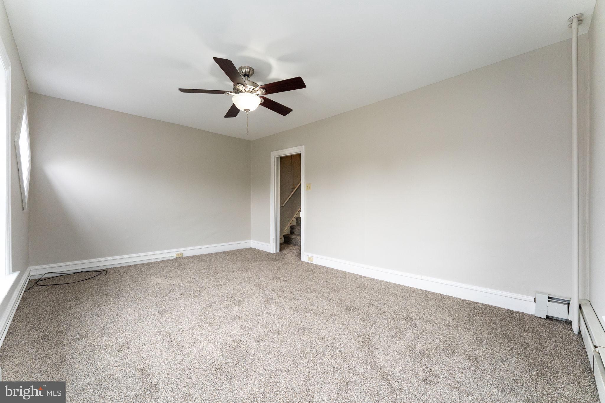 255 Noble Street, Unit B Souderton, PA 18964 - Photo 8 of 15 an empty room with a ceiling fan and window