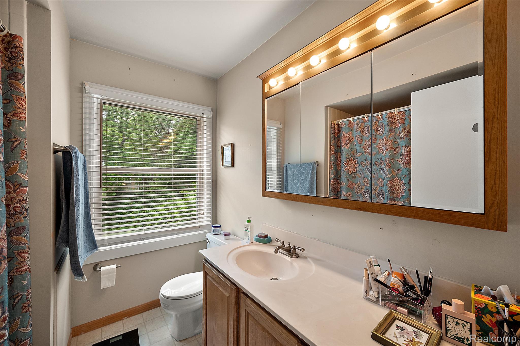 930 Little Hill Court Rochester, MI 48307 - Photo 34 of 38 Full bathroom featuring a single vanity with a white countertop and wood-finish cabinetry