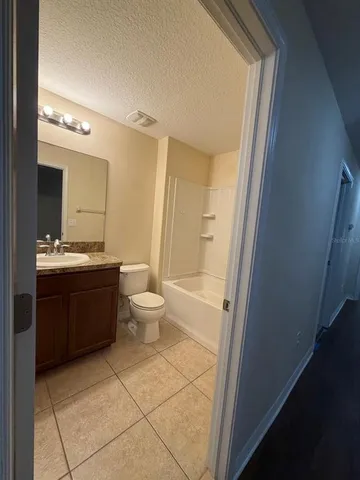 a bathroom with a double vanity sink toilet and shower