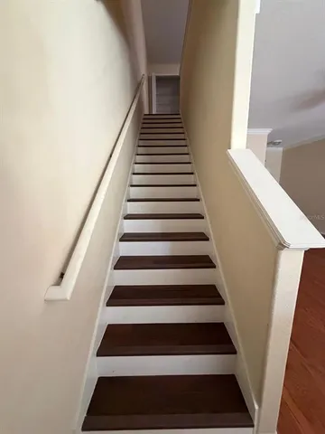 a view of a livingroom with a floor to ceiling window and an entryway