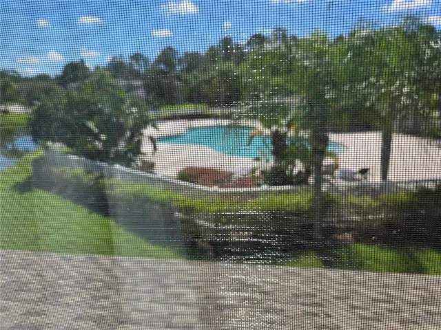 a view of a swimming pool with a yard