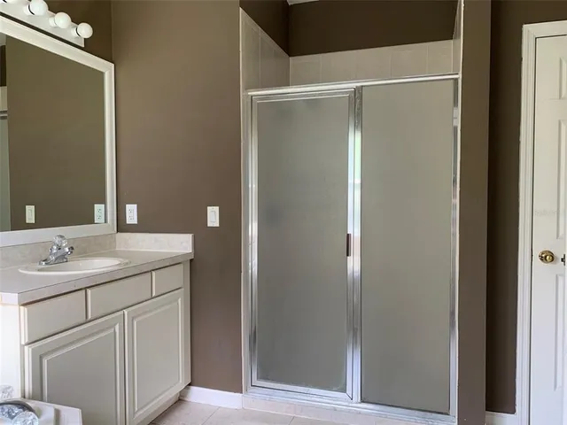 a bathroom with a granite countertop sink and mirror