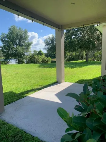a view of a field with sitting area and garden