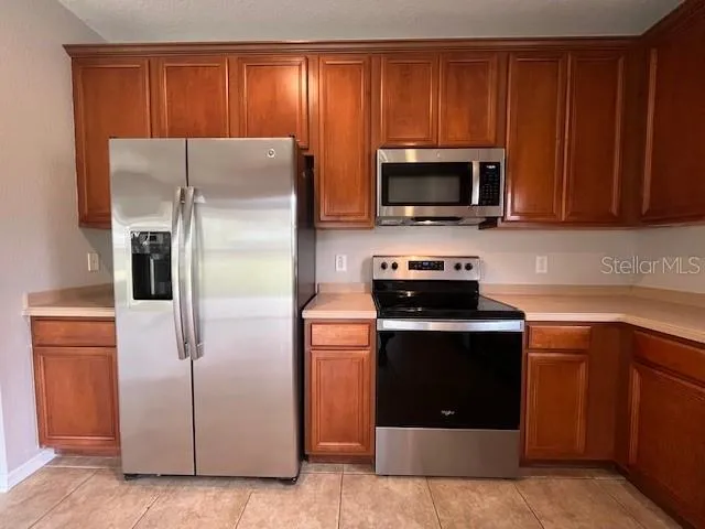 a kitchen with a refrigerator stove and microwave