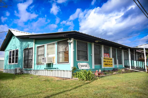 a backyard of a house with plants and outdoor seating