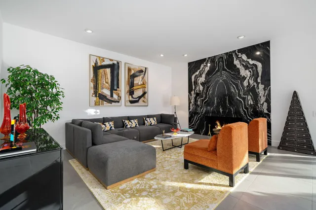 a living room with furniture and a potted plant