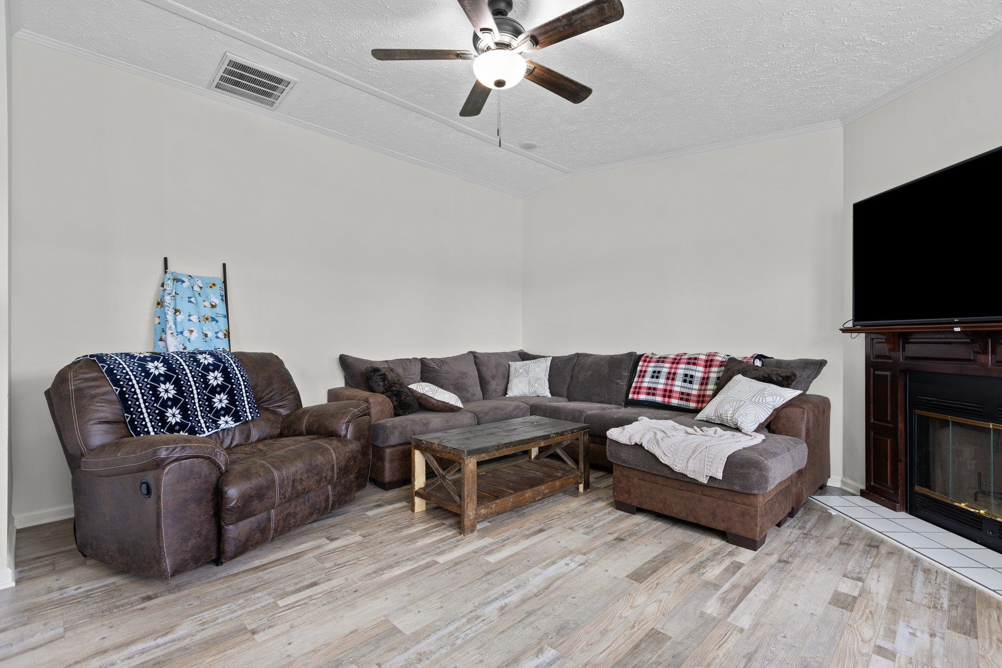 8148 Brooks Road Kenly, NC 27542 - Photo 14 of 38 a living room with furniture and a flat screen tv
