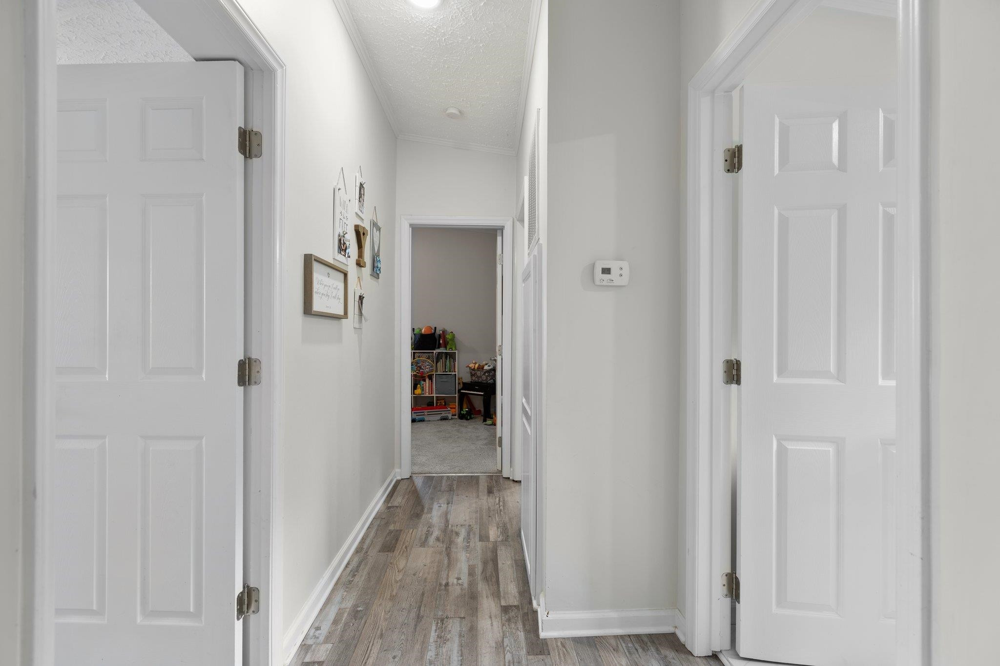 8148 Brooks Road Kenly, NC 27542 - Photo 15 of 38 a view of a hallway with closet and wooden floor