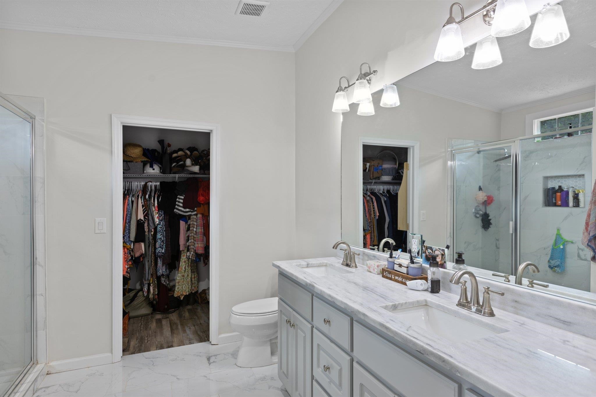 8148 Brooks Road Kenly, NC 27542 - Photo 19 of 38 a bathroom with a sink a toilet and a large mirror