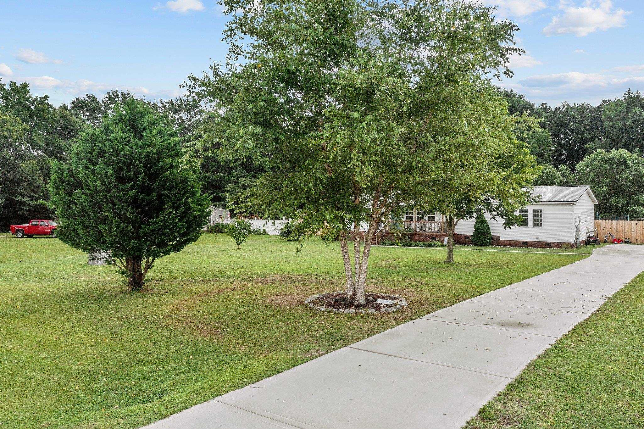 8148 Brooks Road Kenly, NC 27542 - Photo 27 of 38 a tree in the middle of a garden