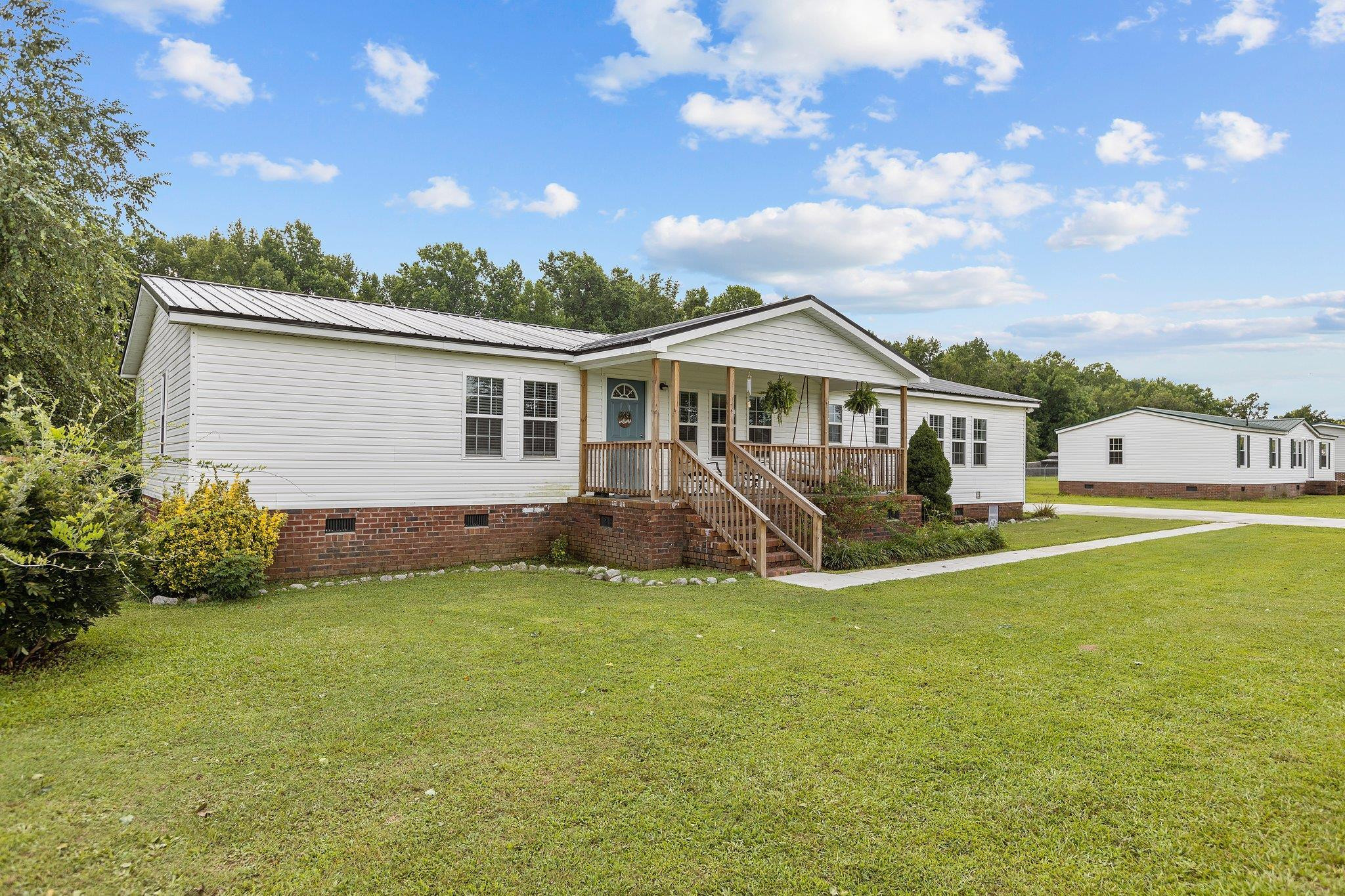 8148 Brooks Road Kenly, NC 27542 - Photo 30 of 38 a view of a house with a yard and sitting area