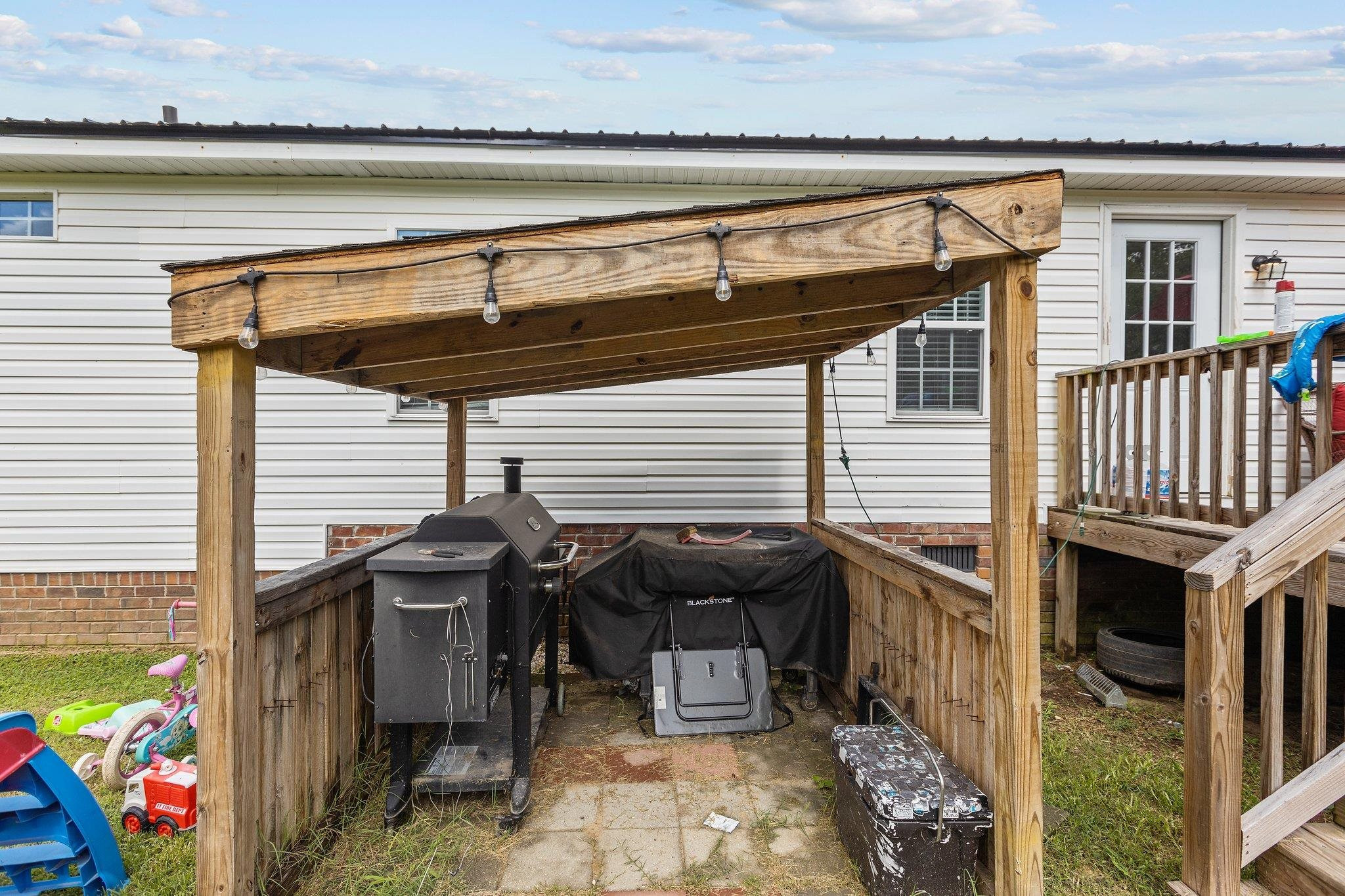 8148 Brooks Road Kenly, NC 27542 - Photo 36 of 38 a view of a patio with table and chairs with wooden floor and plants