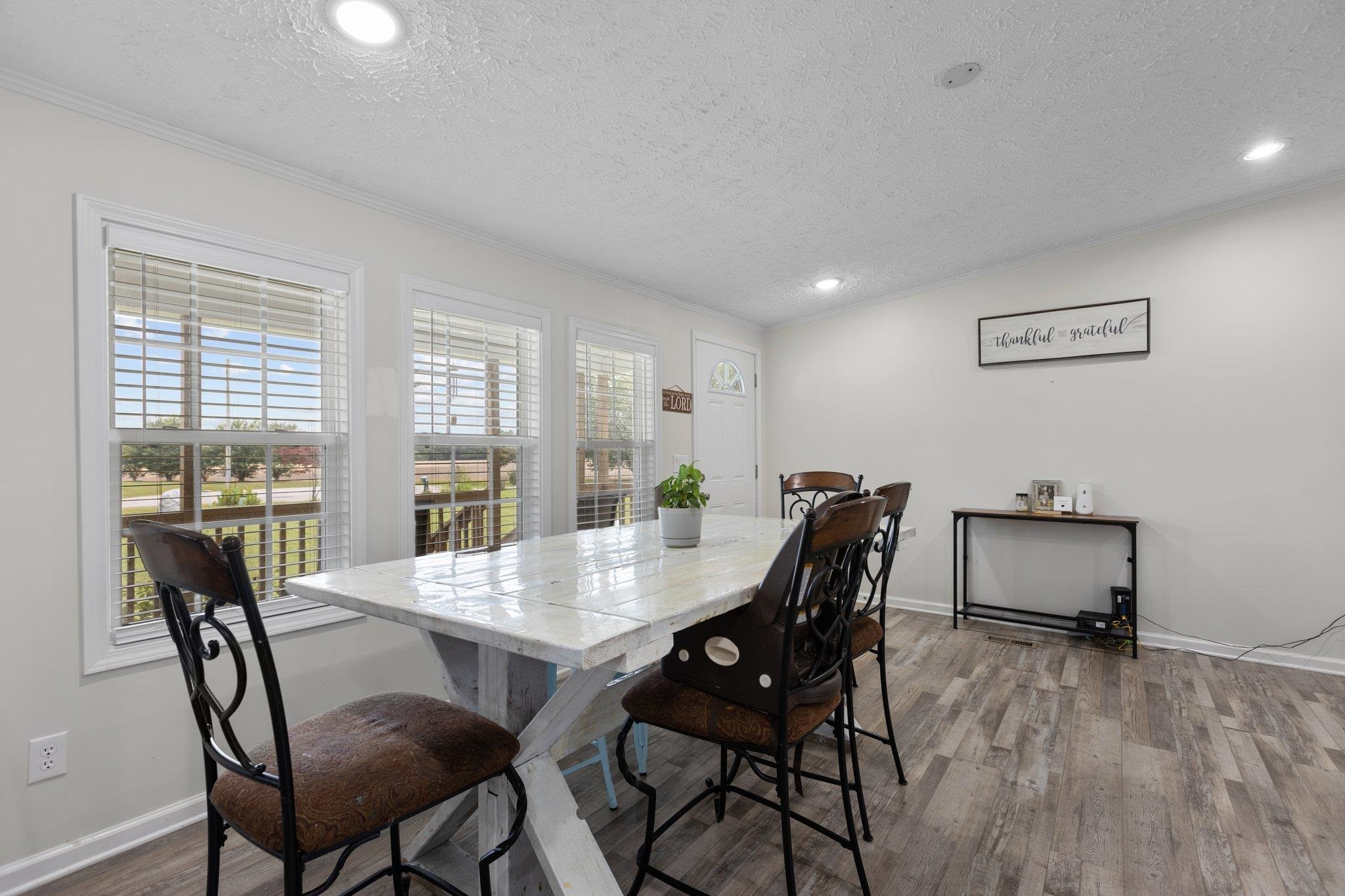 8148 Brooks Road Kenly, NC 27542 - Photo 5 of 38 a view of a dining room with furniture window and wooden floor