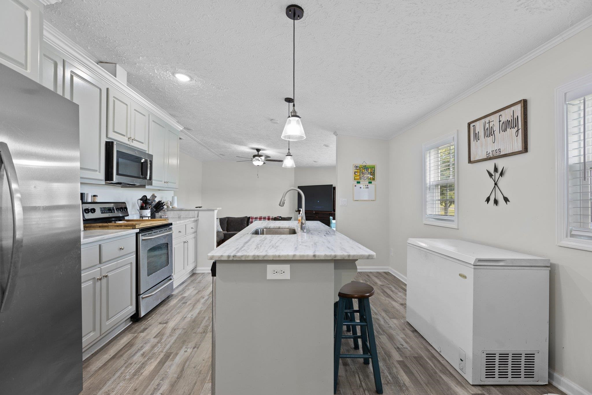 8148 Brooks Road Kenly, NC 27542 - Photo 7 of 38 a kitchen with kitchen island granite countertop appliances cabinets a sink and a counter top space