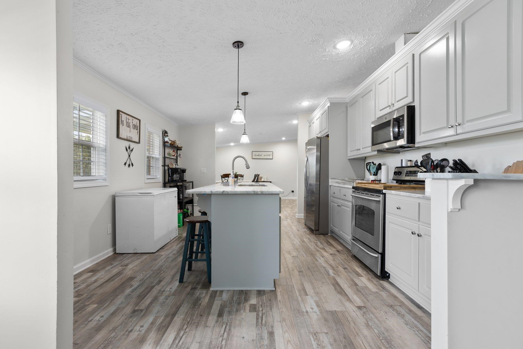 8148 Brooks Road Kenly, NC 27542 - Photo 9 of 38 a kitchen with white cabinets and stainless steel appliances