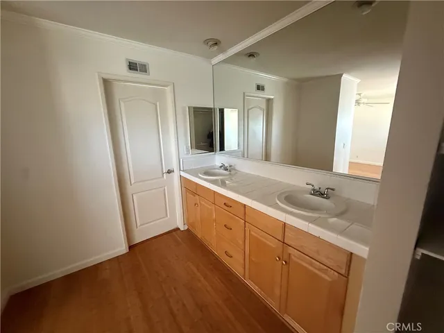 a bathroom with a double vanity sink and mirror