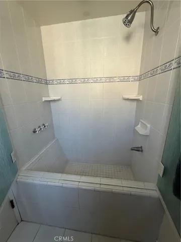 a bathroom with a shower and a shower