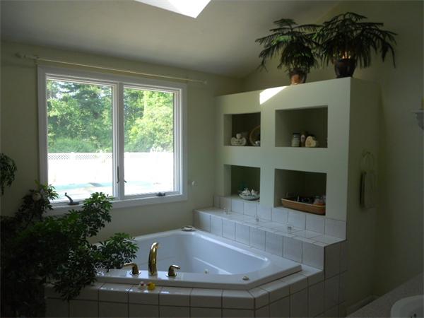 15 Laurel Road Bolton, MA 01740 - Photo 12 of 21 a bath tub sitting in a bathroom next to a window