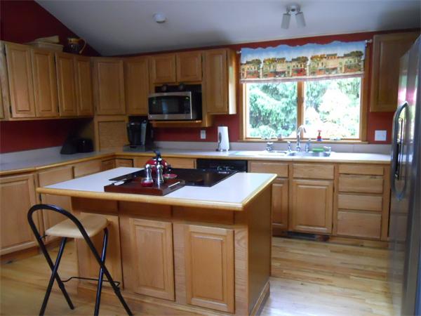 15 Laurel Road Bolton, MA 01740 - Photo 6 of 21 a kitchen with kitchen island granite countertop a sink appliances and cabinets