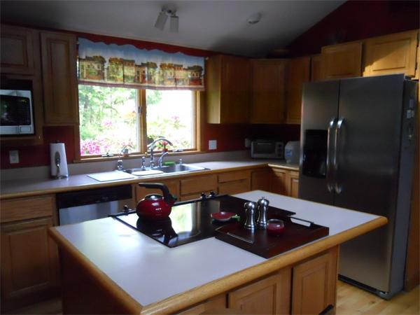 15 Laurel Road Bolton, MA 01740 - Photo 7 of 21 a kitchen with a sink a counter top space and a large window