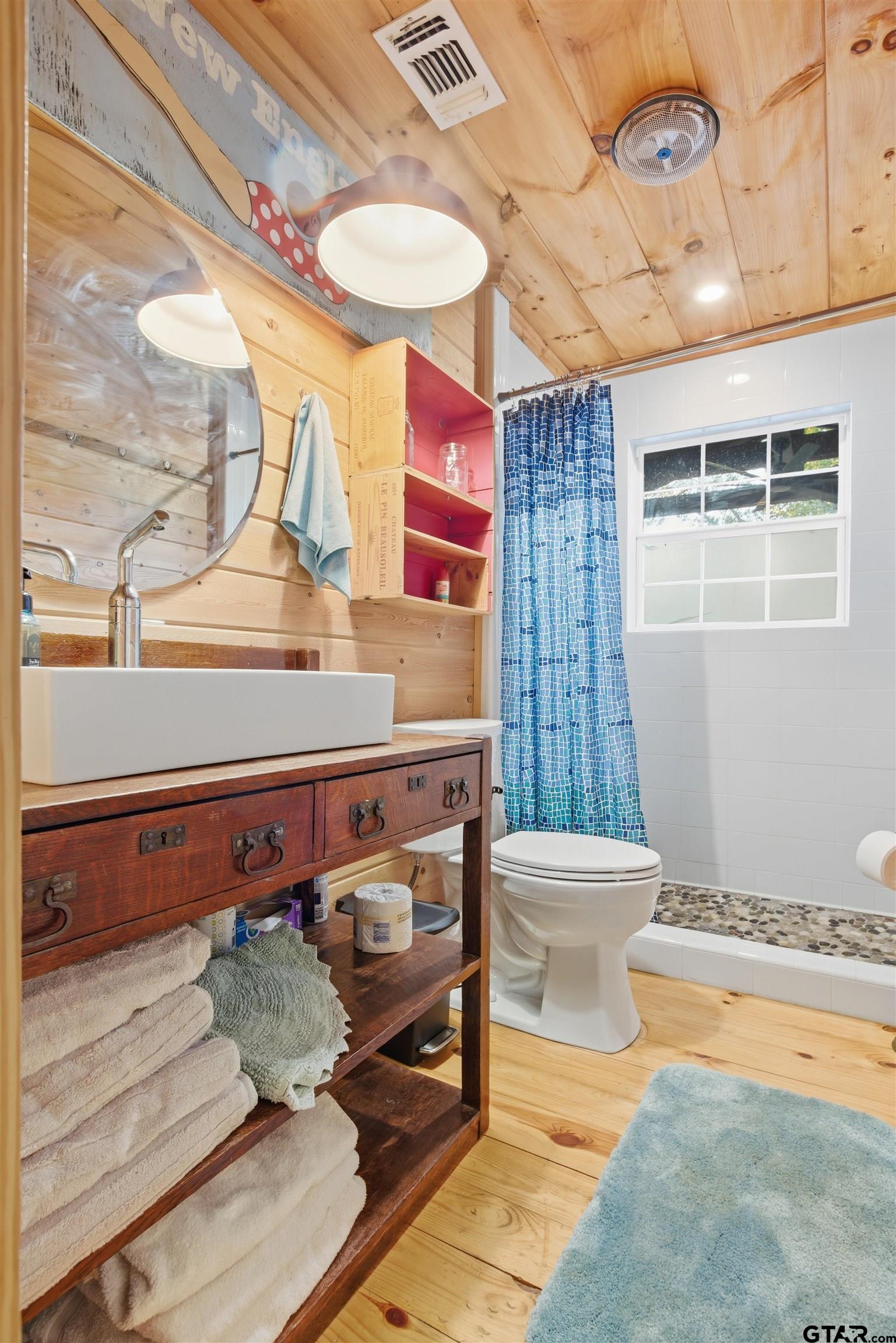 14525 Lake Road West Tyler, TX 75709 - Photo 15 of 30 a bathroom with a sink a toilet and shower