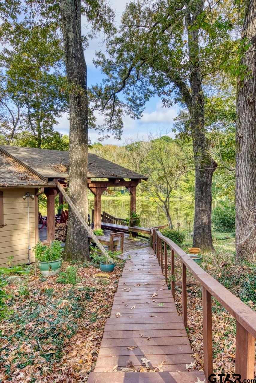 14525 Lake Road West Tyler, TX 75709 - Photo 18 of 30 a view of a pathway of a house with wooden bridge