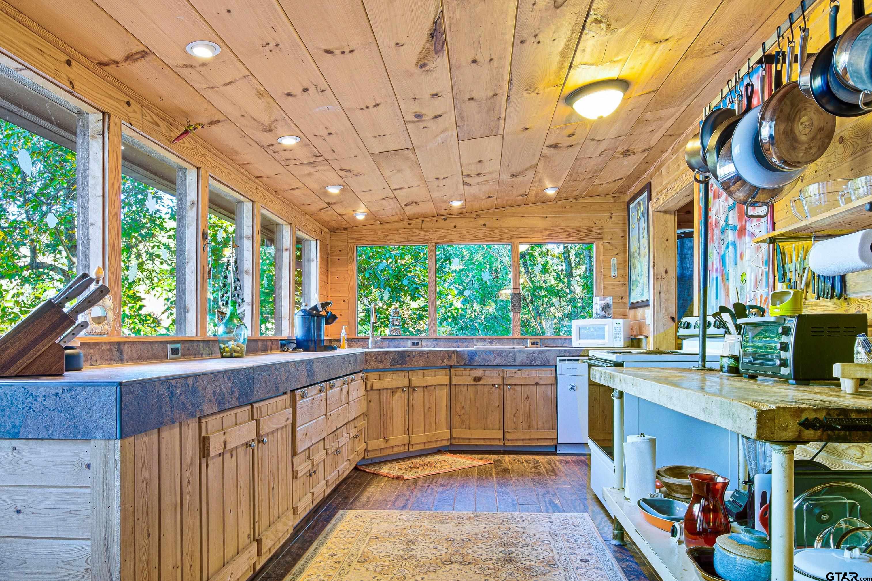 14525 Lake Road West Tyler, TX 75709 - Photo 25 of 30 a view of a kitchen with kitchen island a large window cabinets and stainless steel appliances