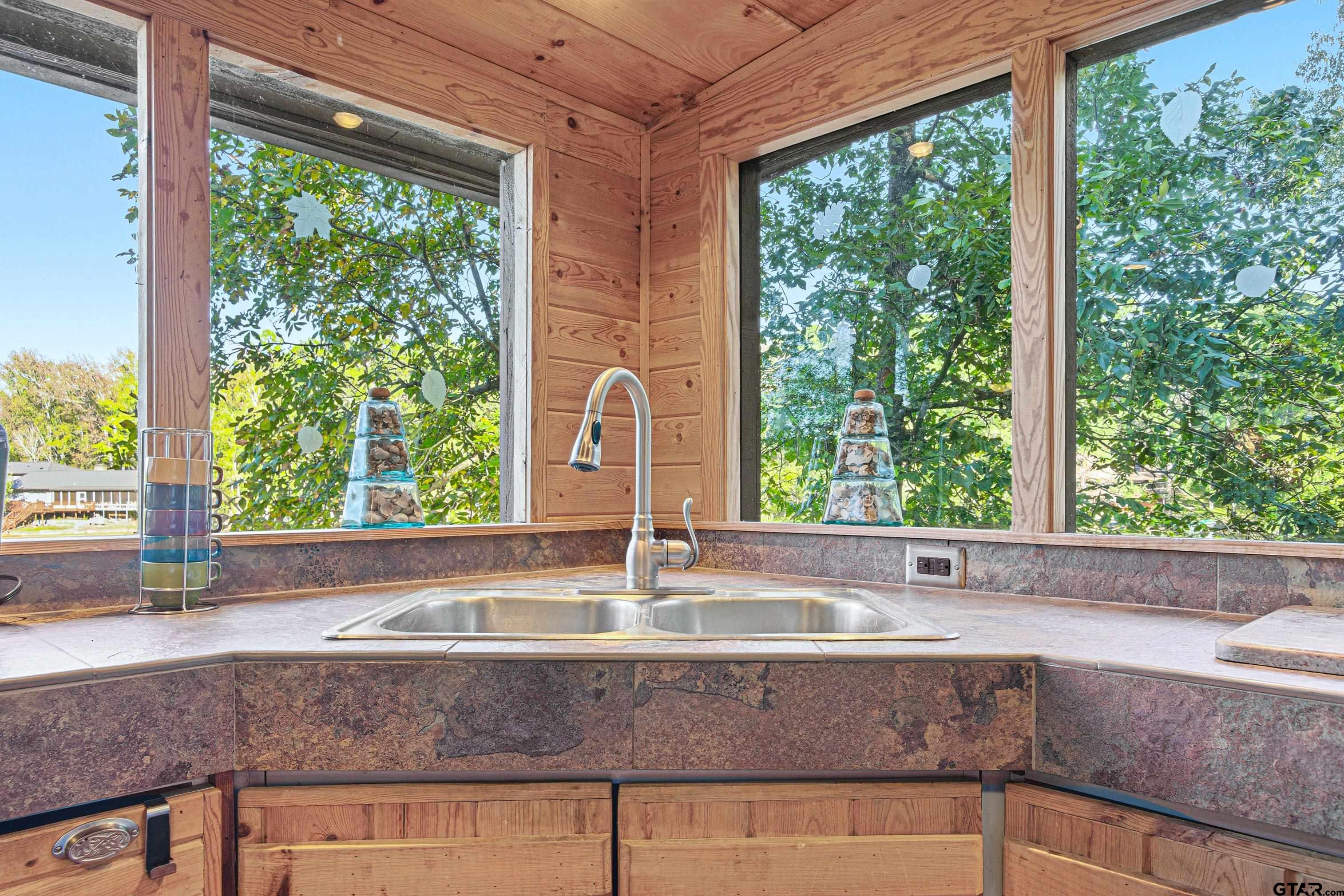 14525 Lake Road West Tyler, TX 75709 - Photo 26 of 30 a kitchen sink sitting in a kitchen next to a window