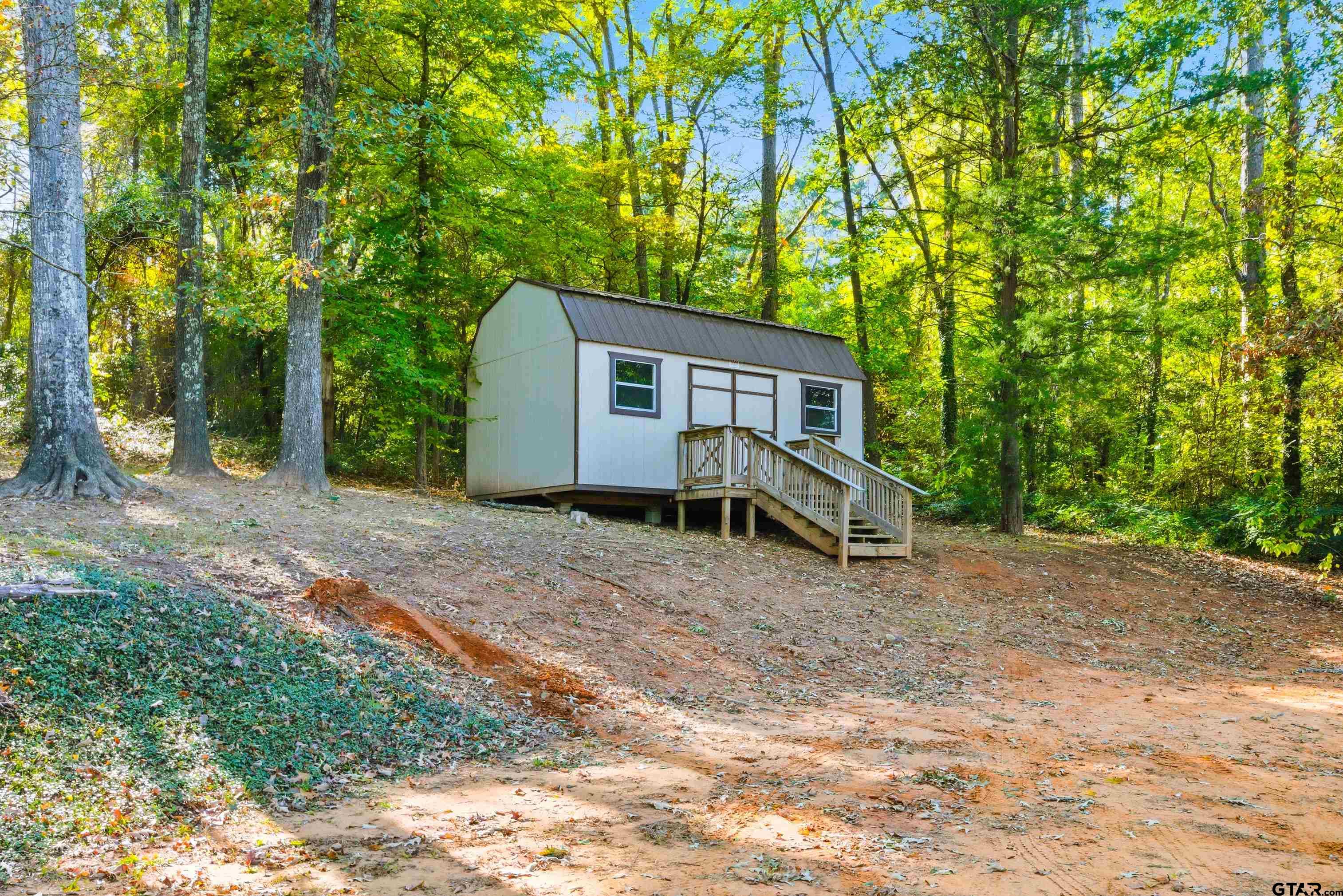 14525 Lake Road West Tyler, TX 75709 - Photo 7 of 30 a house with trees in front of it