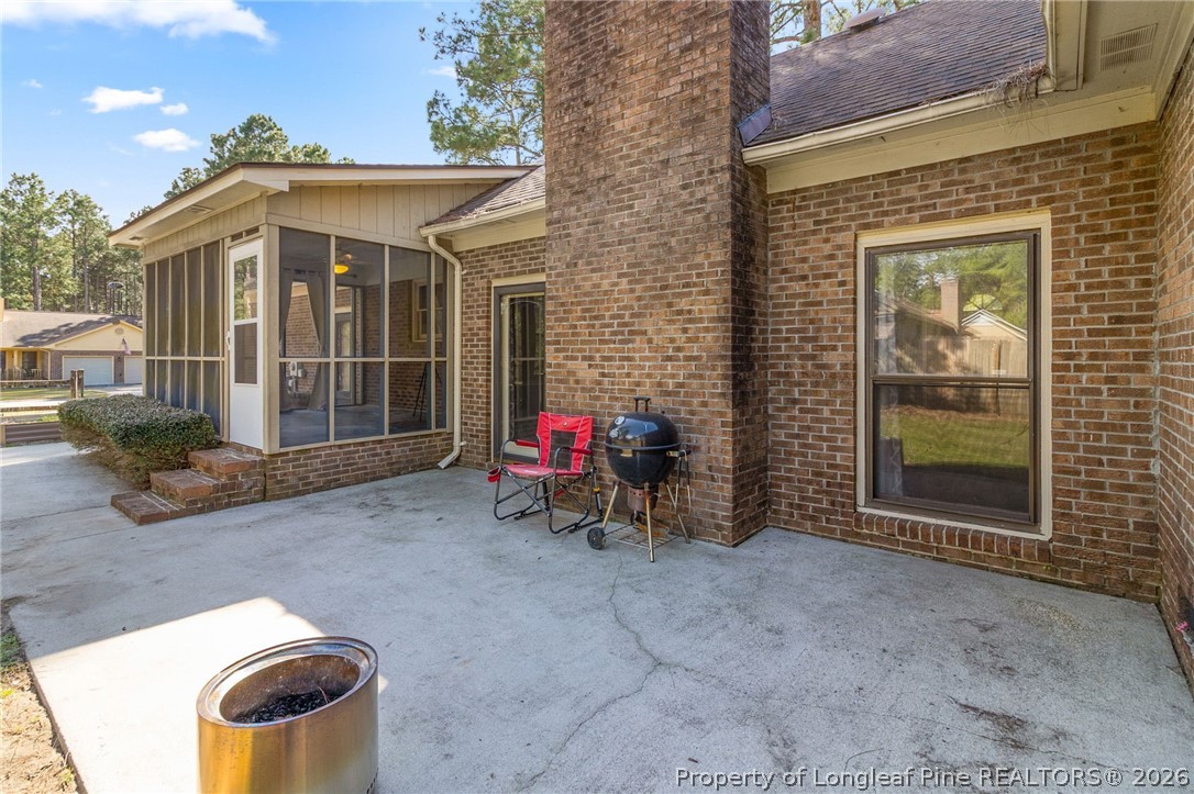 7756 Dragonhead Road Fayetteville, NC 28311 - Photo 36 of 42 a view of a chair and fire pit in backyard of the house