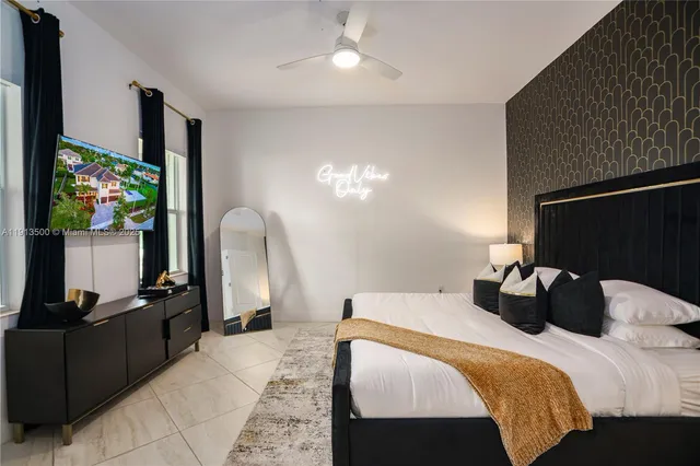 a bedroom with two beds a potted plant with the dresser and wooden floor